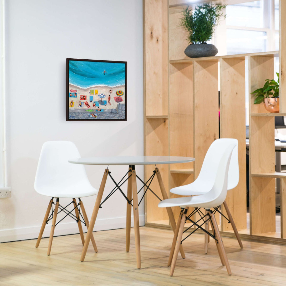 A colorful print of Day at the Beach by Artglober hangs in a modern kitchen.