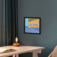Framed canvas print, Club Nautico, by Artglober hanging on teal wall.