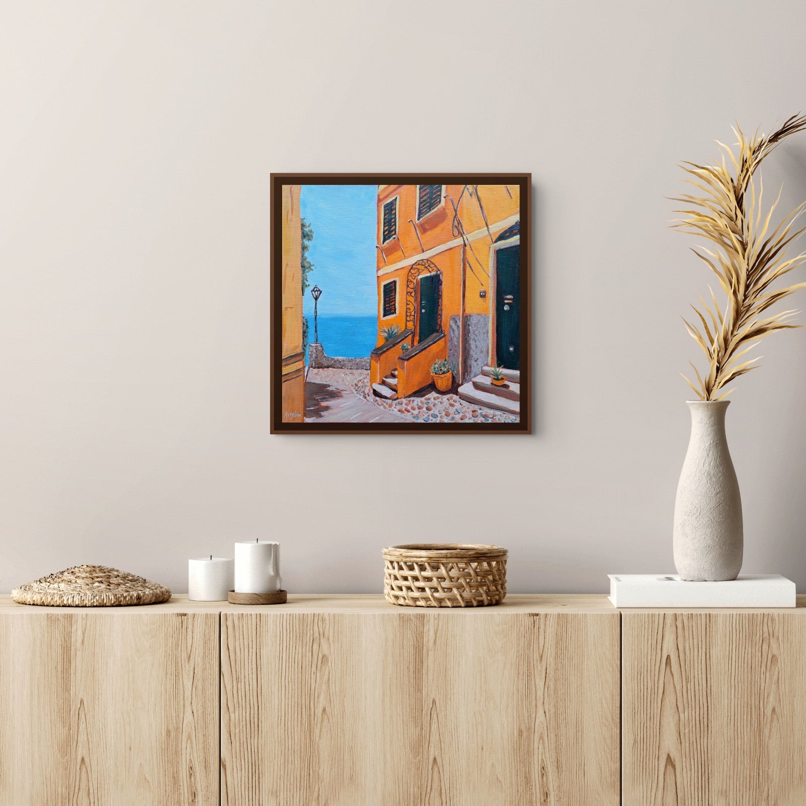 A framed canvas print of, "Orange Creamsicle House" by Artglober of a Mediterranean coastal street with orange buildings and a blue sea.