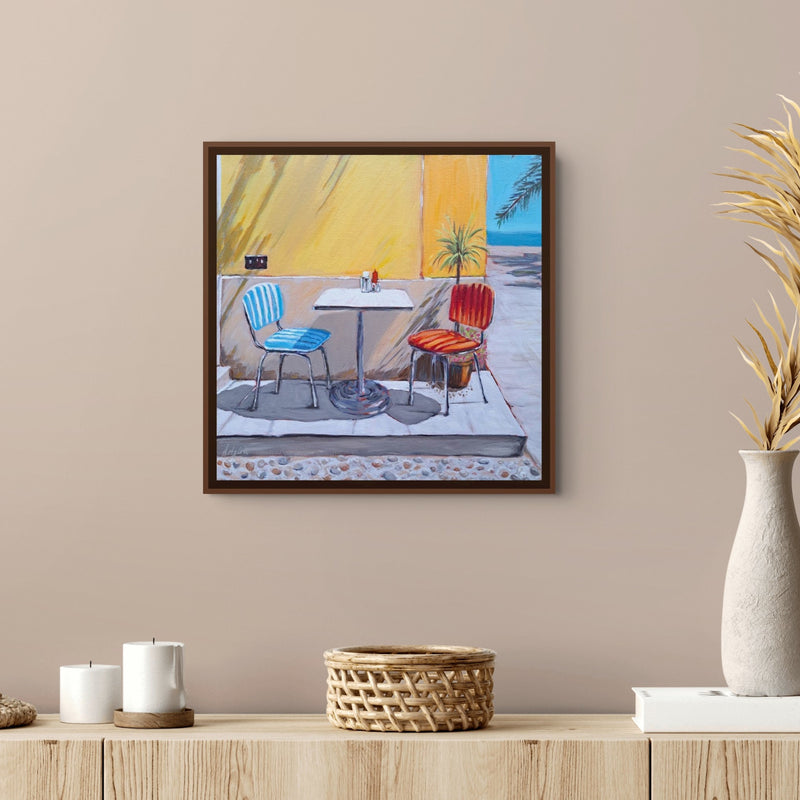 Italian Seaside Bistro framed square art print by Artglober above a wood console table on a beige wall.